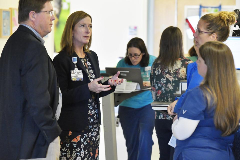 Chief Medical Officer Jerry Bridgham, from left, and Wolfson Children's Hospital's new president, Allegra Jaros, interact with registered nurse Carie Murphy, a pediatric hematology/oncology education specialist, and Kim Taylor, a pediatric hematology social worker.