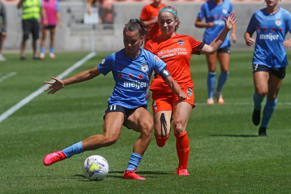 Chicago Red Stars' Sarah Gorden, front, plays the ball as Houston Dash's Bri Visalli defends during the second half of an NWSL Challenge Cup.
