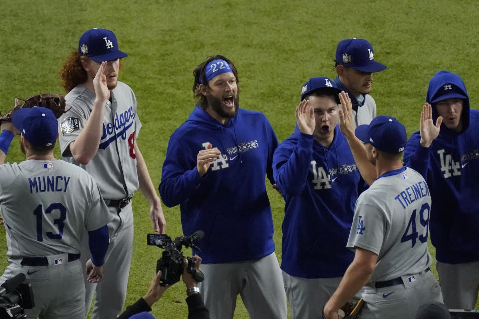 Los Angeles Dodgers starting pitcher Clayton Kershaw, center, celebrates after their win against the Tampa Bay Rays in Game 5 of the baseball World Series Sunday, Oct. 25, 2020, in Arlington, Texas. Dodgers beat the Rays 4-2 to lead the series 3-2 games. (AP Photo/Sue Ogrocki)