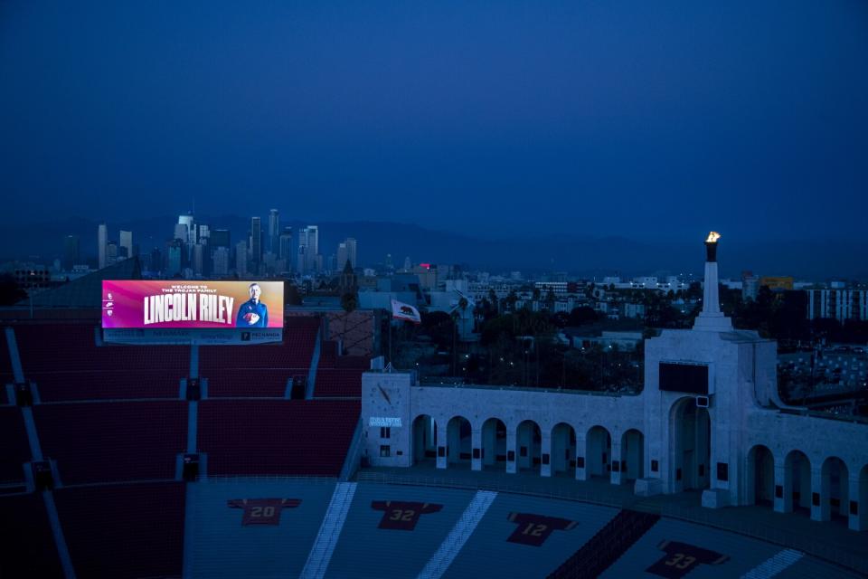 A giant video board at the Coliseum features Lincoln Riley and his name