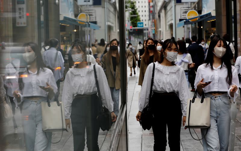 FILE PHOTO: People wearing protective masks in a shopping district in Tokyo,