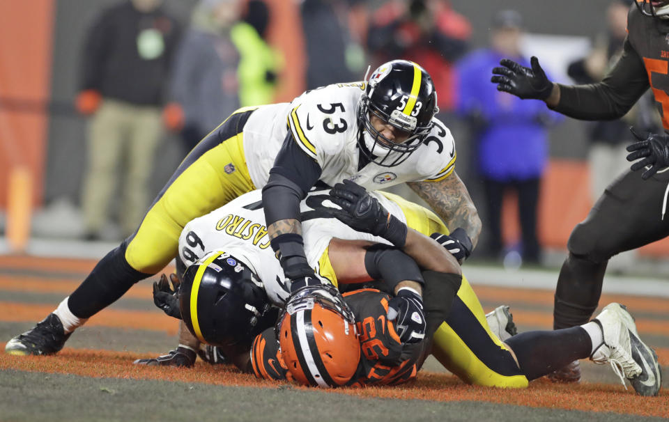 Cleveland's Myles Garrett (95) is punched by Steelers center Maurkice Pouncey (53) and tackled by guard David DeCastro in disturbing incident of Thursday night's game in Cleveland. (AP Photo/Ron Schwane)