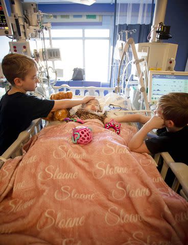 <p>Courtesy of Brittany Johnson</p> Brittany Johnson's sons with her daughter, Sloane, in the NICU