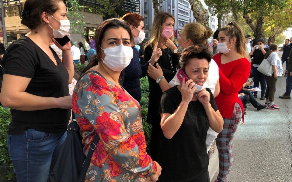 People stand outside their homes in Izmir - Ismail Gokmen /AP