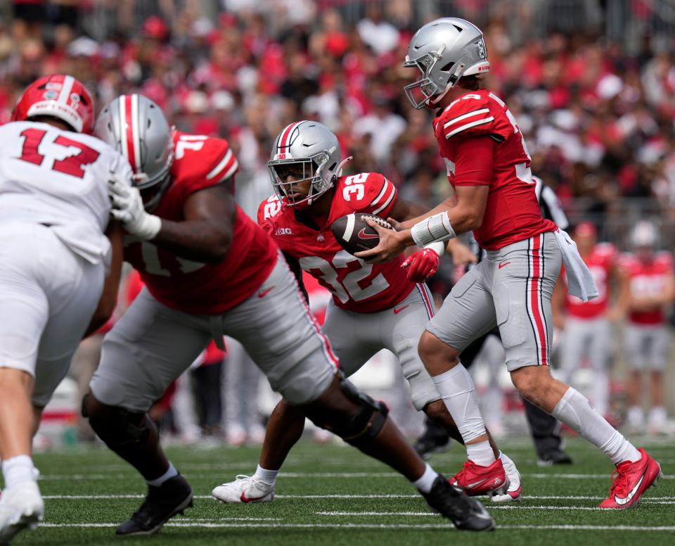 Sept. 9, 2023; Columbus, Oh., USA;  Ohio State Buckeyes quarterback Devin Brown (33) hands off to Ohio State Buckeyes running back TreVeyon Henderson (32) during the first half of Saturday's NCAA Division I football game at Ohio Stadium. 