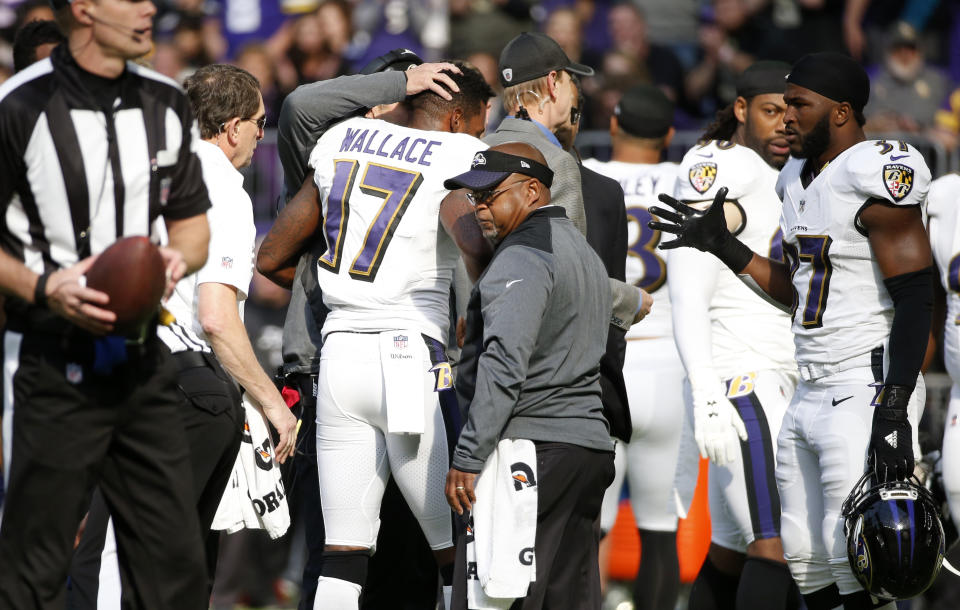 Ravens wide receiver Mike Wallace (17) is helped off the field after a hit from Vikings safety Andrew Sendejo. (AP)