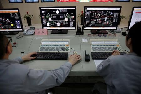 Employees work inside newly launched waste-to-energy plant by Suzhou Wujiang Everbright Environmental Energy Ltd in Wujiang of Suzhou, Jiangsu province, China, November 8, 2016. Picture taken November 8, 2016. REUTERS/Aly Song