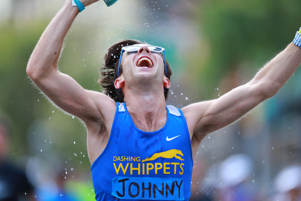 This runner pours water on himself after reaching Manahttan in the 2019 New York City Marathon. (Photo: Gordon Donovan/Yahoo News)