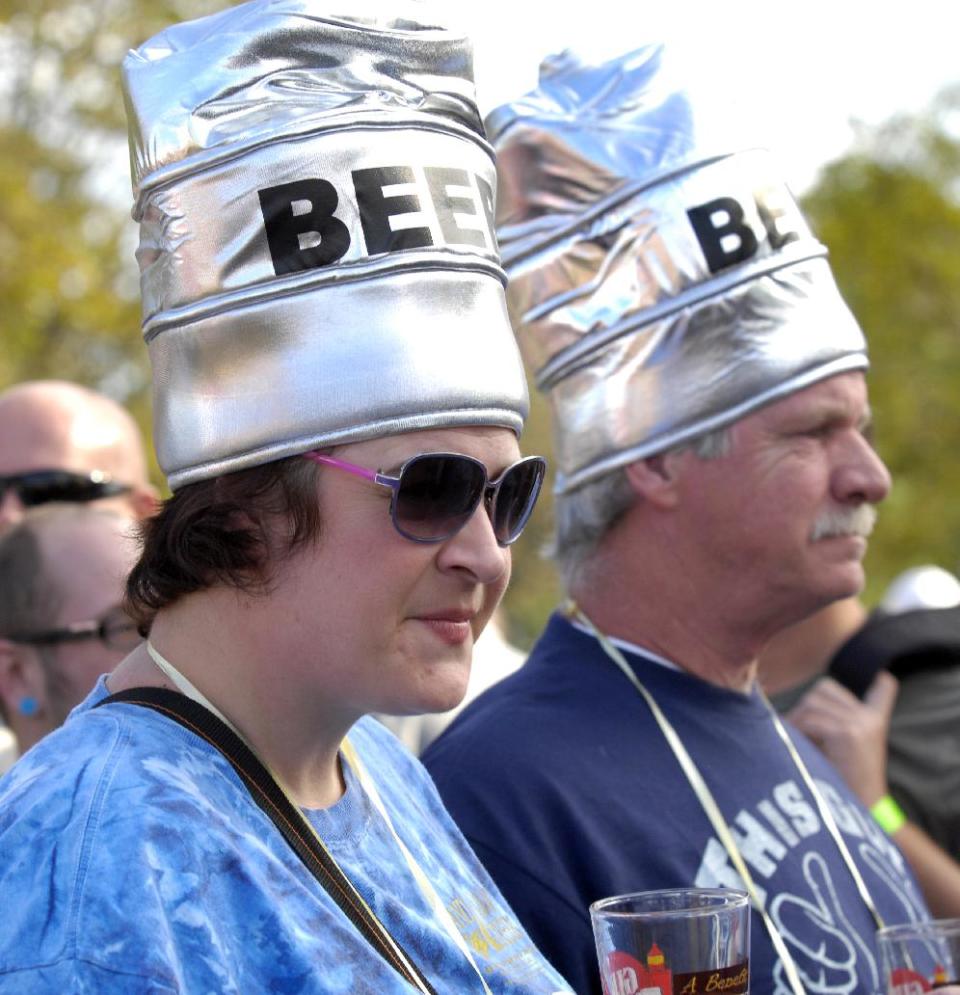 In this Sept. 17, 2011 photo, Amber Hill, left, and her father, Howard Hill, wait to sample another beer at the annual Great Lakes Brew Fest at the Racine Zoo, in Racine, Wis. An explosion of interest in home beer brewing is forcing lawmakers across the country to review long-forgotten alcohol laws, some of which date back to Prohibition. (AP Photo/Journal Times, Mark Hertzberg)