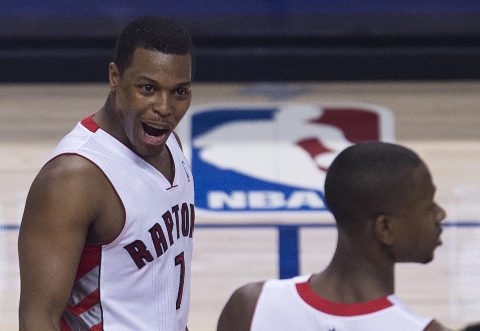 Toronto Raptors guard Kyle Lowry, left, reacts with teammate Terrence Ross, right, as they play against the Brooklyn Nets during the second half of Game 5 of the opening-round NBA basketball playoff series in Toronto, Wednesday, April 30, 2014. (AP Photo/The Canadian Press, Nathan Denette)