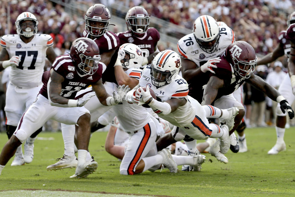 Auburn running back JaTarvious Whitlow (28) dives over the goal line for a touchdown against Texas A&M during the second half of an NCAA college football game, Saturday, Sept. 21, 2019, in College Station, Texas. (AP Photo/Sam Craft)