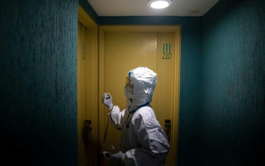 a covid patient in a hotel room - Leonardo Fernandez Viloria/ Getty Images