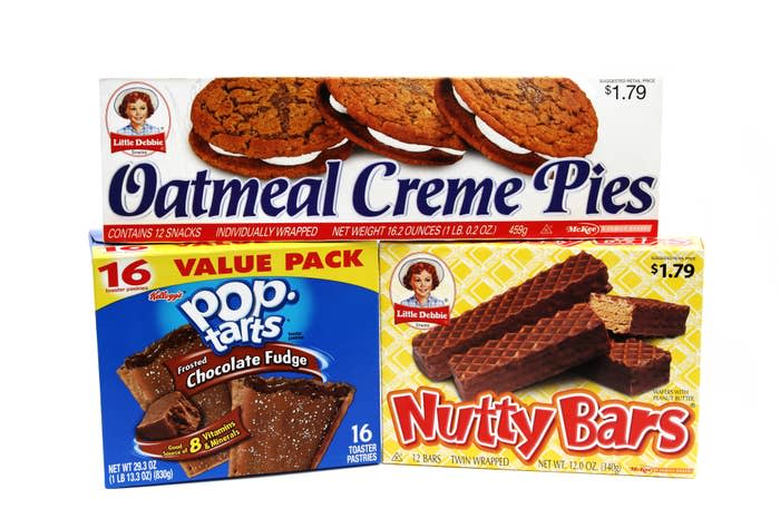 Boxes of Little Debbie Oatmeal Creme Pies, Pop-Tarts Chocolate Fudge, and Nutty Bars arranged together