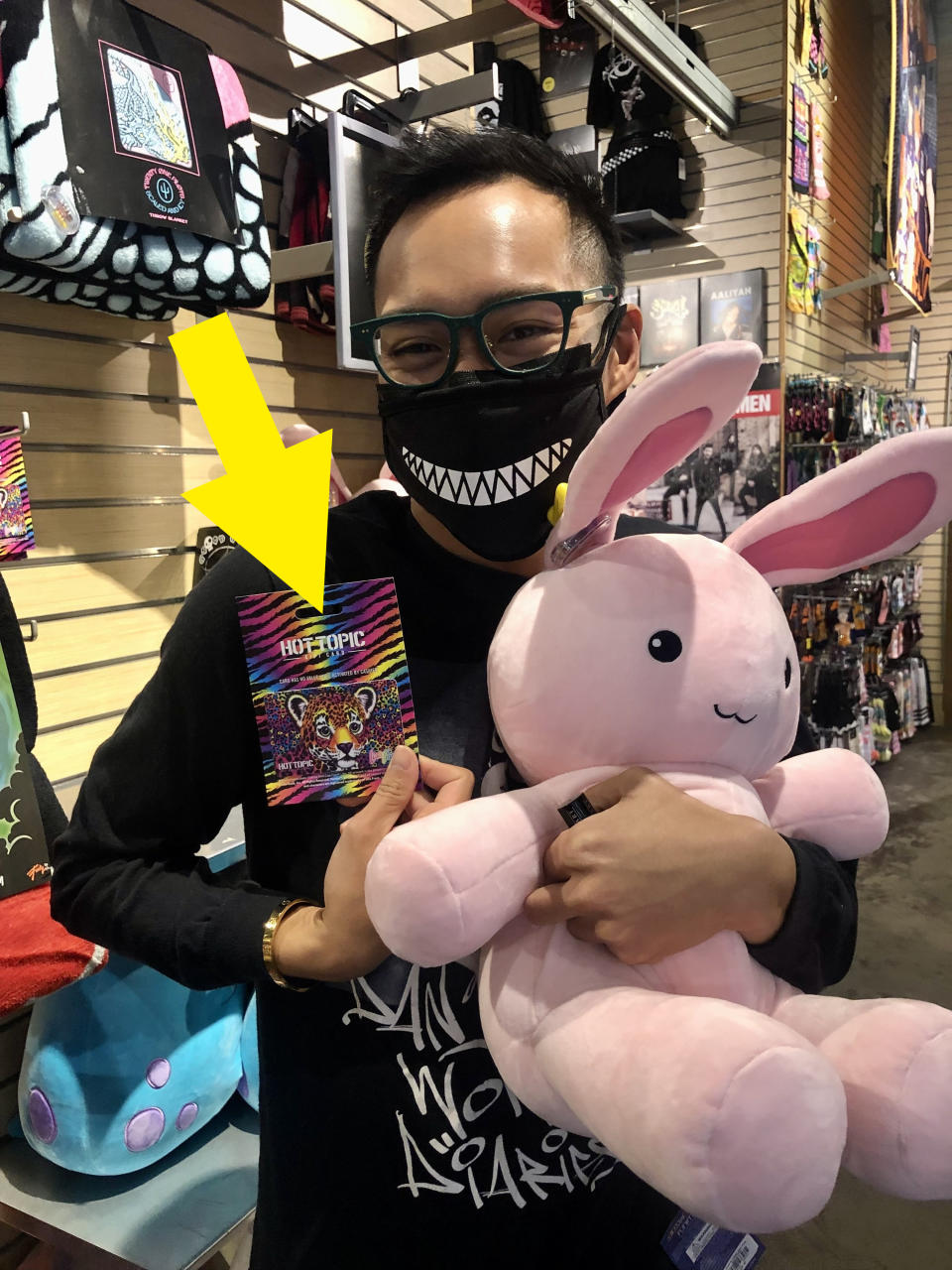 Author holding a rabbit plush animal and a colorful Lisa Frank gift card