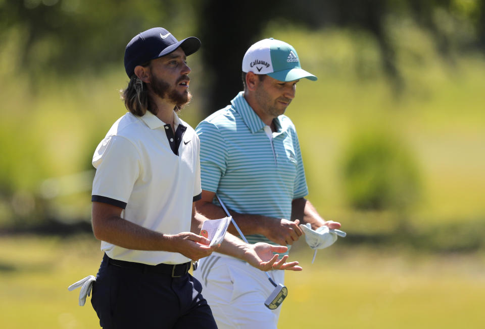 Tommy Fleetwood, left, and teammate Sergio Garcia walk up the 15th fairway during the final round of the PGA Zurich Classic golf tournament at TPC Louisiana in Avondale, La., Sunday, April 28, 2019. (AP Photo/Gerald Herbert)