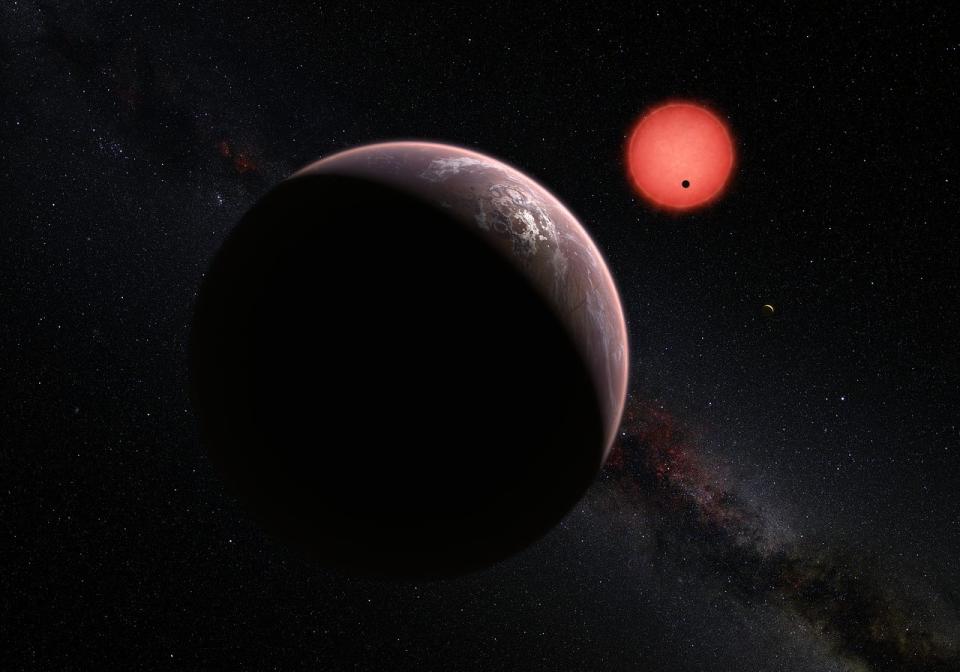 Scientists have found three alien planets orbiting an ultra-cool dwarf star about 40 light-years from Earth and they might have the potential to support life. This artist's illustration depicts a view of the three TR