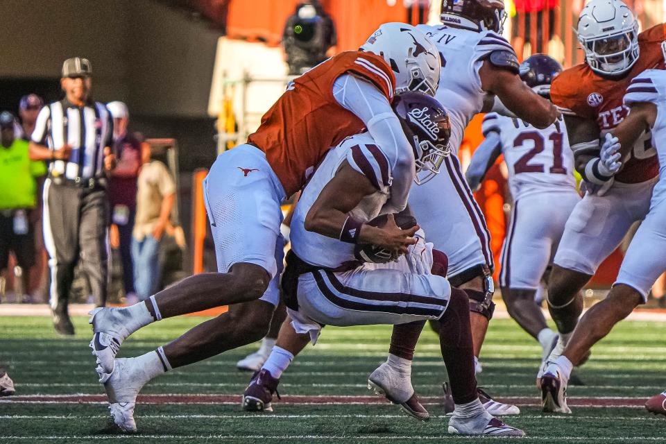 Texas edge rusher Colin Simmons sacks Mississippi State quarterback Michael Van Buren Jr. during Saturday's 35-13 win at Royal-Memorial Stadium. Simmons, a freshman, leads the team with four sacks this season, one ahead of middle linebacker Anthony Hill Jr.