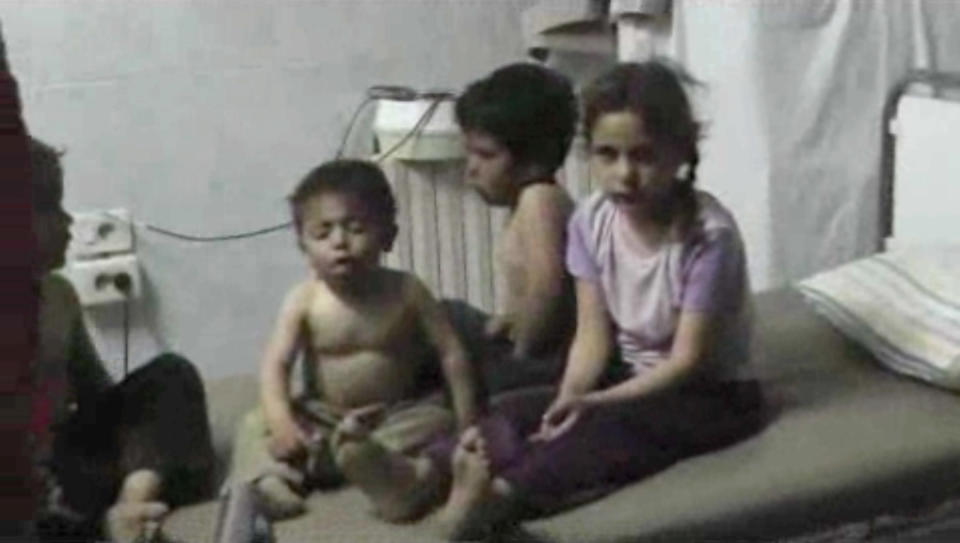 In this Friday, April 11, 2014 image made from amateur video, provided by Shams News Network, a loosely organized anti-Assad group based in and out of Syria that claim not to have any connection to Syrian opposition parties or any other states, and is consistent with independent AP reporting, shows children on a bed at a hospital room in Kfar Zeita, some 200 kilometers (125 miles) north of Damascus, Syria. Syrian government media and rebel forces said Saturday, April 12, 2014 that poison gas had been used in the village on Friday, injuring scores of people, while blaming each other for the attack. (AP Photo/Shams News Network)