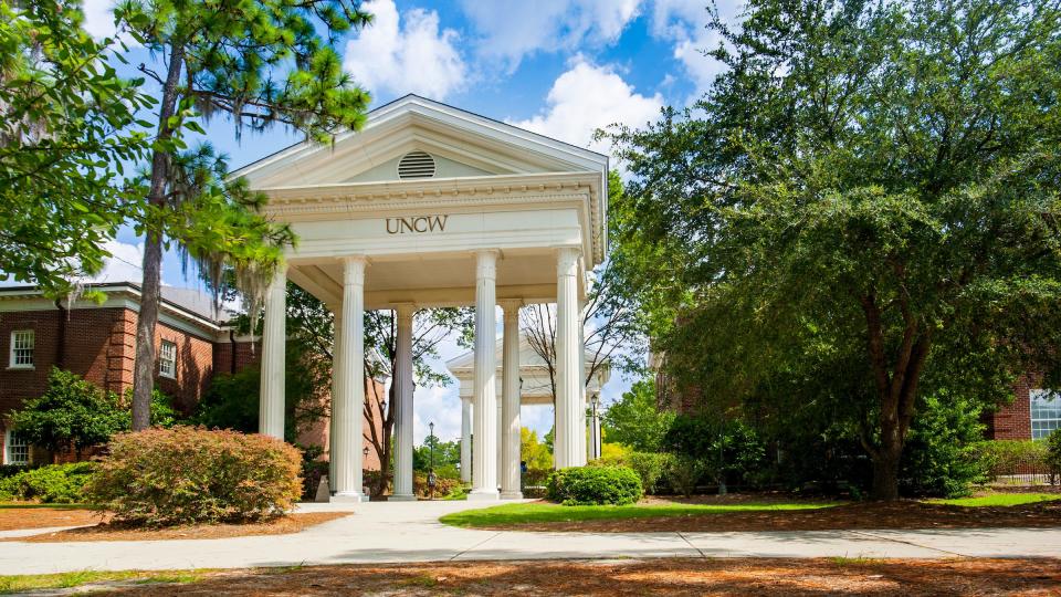 UNCW Roman arches above pedestrian traffic near the Northeast entrance to campus Aug. 18, 2017.