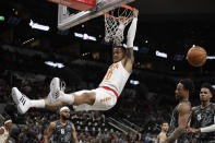 Atlanta Hawks forward John Collins (20) scores over San Antonio Spurs guard DeMar DeRozan, second from right, during the first half of an NBA basketball game in San Antonio, Friday, Jan. 17, 2020. (AP Photo/Eric Gay)