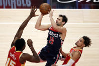 Washington Wizards guard Raul Neto (19) puts up a shot as Atlanta Hawks center Clint Capela (15) tries to block during the second half of an NBA basketball game Wednesday, May 12, 2021, in Atlanta. Atlanta Hawks defeated the Washington Wizards 120-116. (AP Photo/Butch Dill)