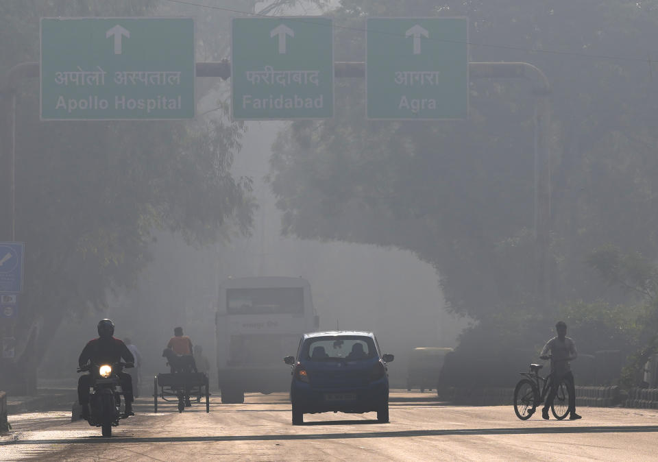 <p>A motorcyclist drives on the wrong side of the road amidst morning haze and toxic smog in New Delhi, India, Wednesday, Nov. 17, 2021. Schools were closed indefinitely and some coal-based power plants shut down as the Indian capital and neighboring states invoked harsh measures Wednesday to combat air pollution after an order from the federal environment ministry panel. (AP Photo/Manish Swarup)</p> 