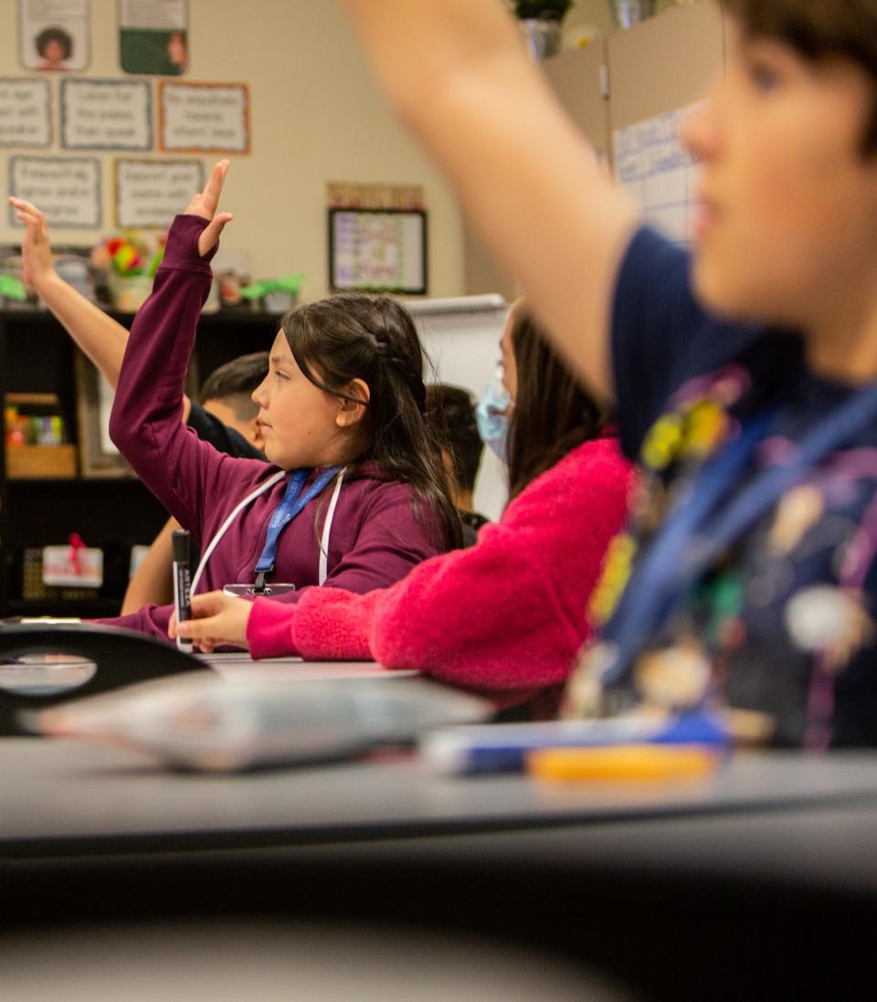 Students raise their hands during a fourth-grade math lesson at the Liberty district's Rainbow Valley Elementary School in Buckeye on April 4, 2023.