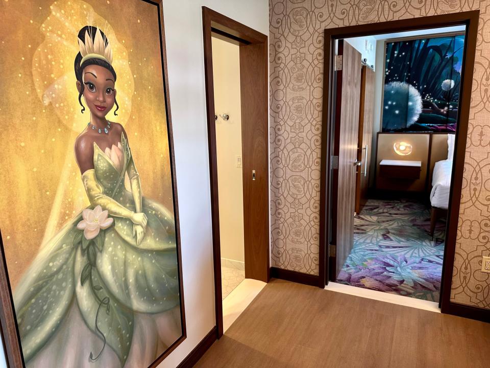 Large painting of Tiana from The Princess and the Frog on a wall in a hotel room