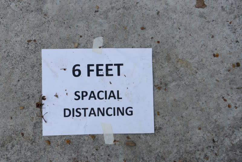 A reminder to practice social distancing seen at West Oakland Middle School during “grab and go” meal distribution while Oakland Unified School District is shutdown due to COVID-19 in Oakland