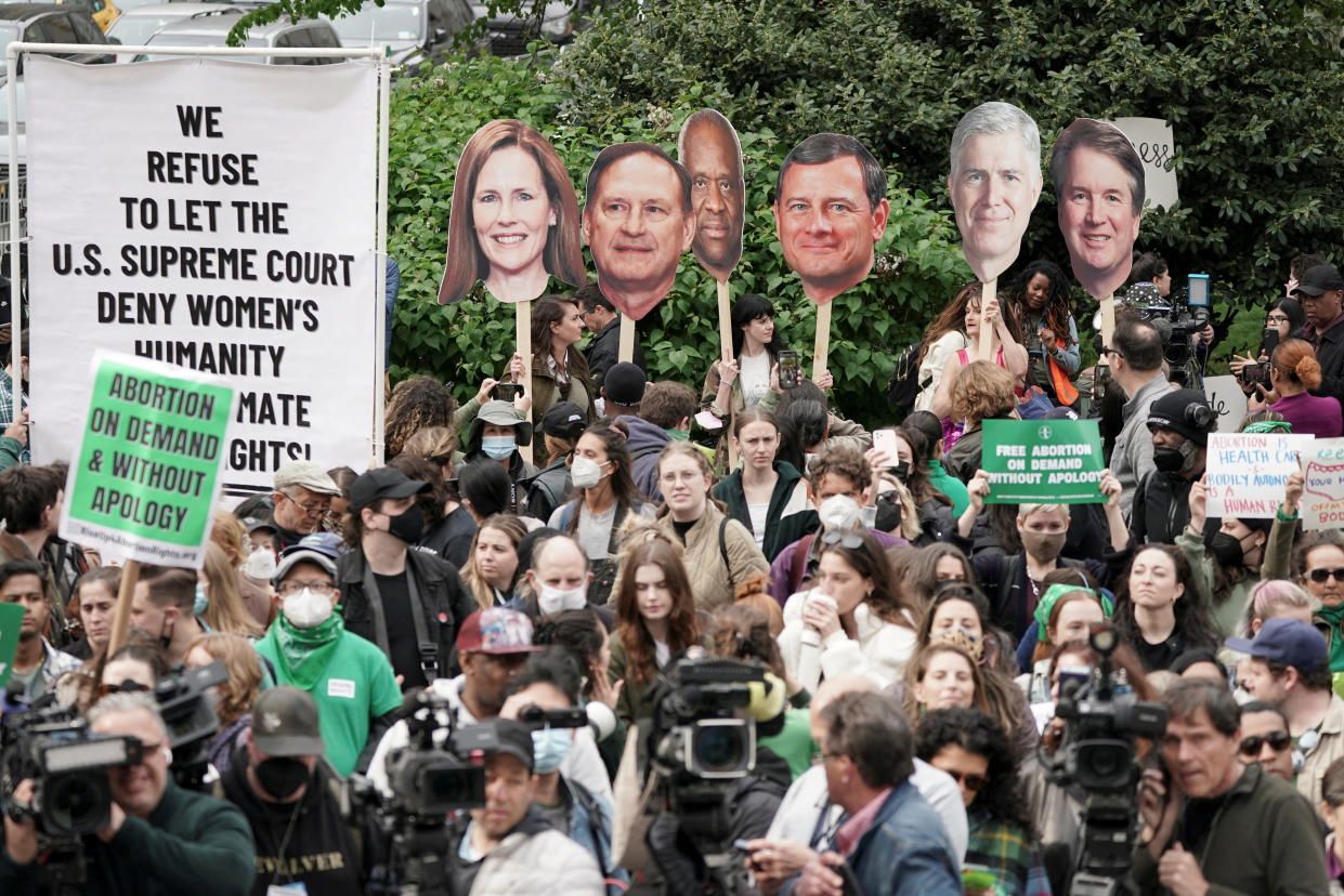 Protesters hold up photographs of Supreme Court justices during an abortion rights demonstration in New York's Foley Square on Tuesday. (Jeenah Moon/Reuters)
