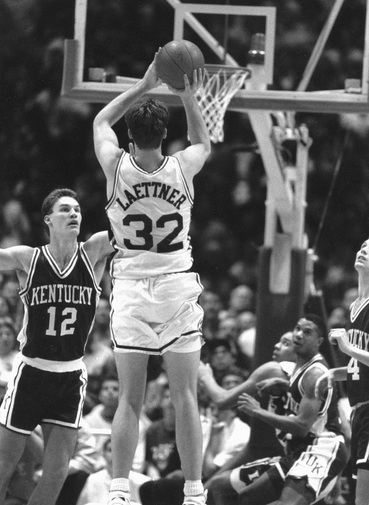 Duke star Christian Laettner gets off a last-second shot to defeat Kentucky in the NCAA Tournament in 1992.