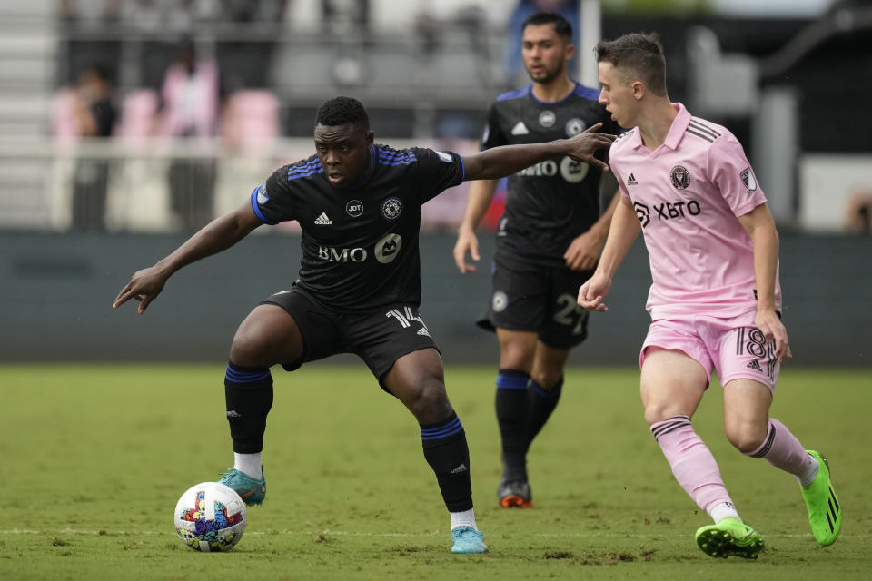 CF Montreal forward Sunusi Ibrahim controls the ball under pressure from Inter Miami defender Harvey Neville, in the second half of an MLS soccer game, Sunday, Oct. 9, 2022, in Fort Lauderdale, Fla. (AP Photo/Rebecca Blackwell)