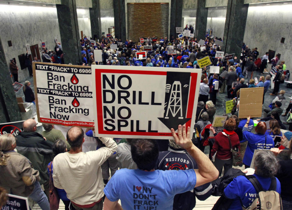 FILE - In this Jan. 23, 2012 file photo, people take part in a rally against hydraulic fracturing of natural gas wells at the Legislative Office Building in Albany, N.Y. In the latest salvo in local battles over gas drilling, a company says it's shutting down wells and stopping free gas to landowners in a western New York town that passed a moratorium on drilling. The town of Avon, 20 miles southwest of Rochester, passed a one-year moratorium on gas drilling and hydraulic fracturing on June 28. Dozens of other towns have enacted similar moratoriums or bans in anticipation of the state completing an environmental review and issuing permits in coming months. (AP Photo/Mike Groll, File)