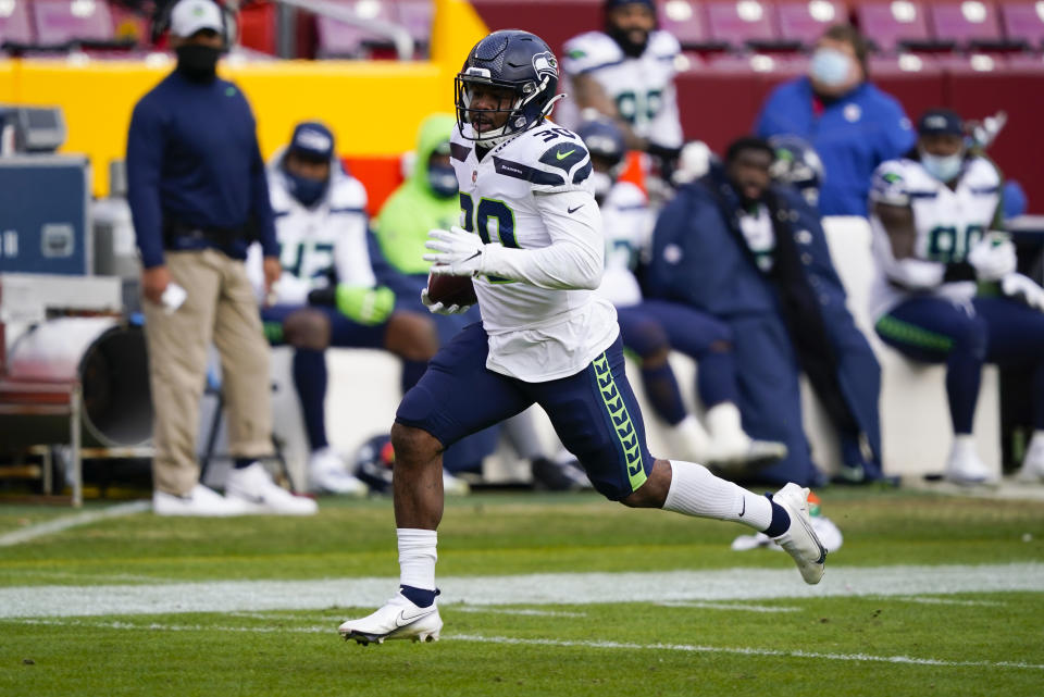 Seattle Seahawks running back Carlos Hyde (30) carries the ball during his 50-yard touchdown run against the Washington Football Team, Sunday, Dec. 20, 2020, in Landover, Md. (AP Photo/Susan Walsh)