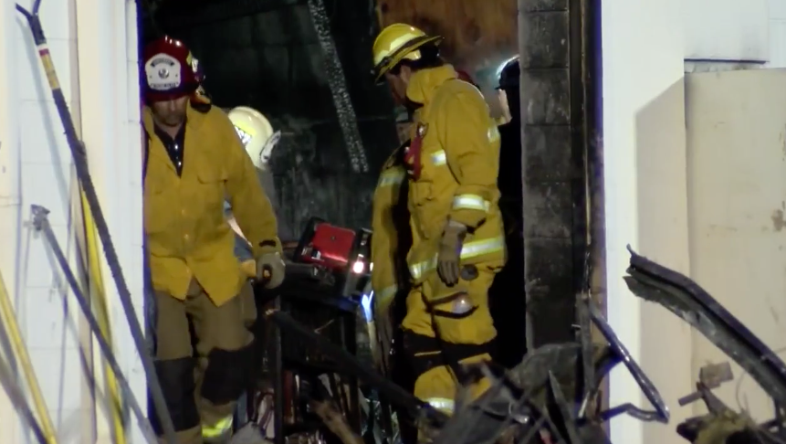 Firefighters are pictured inside Porterville Library after it was burnt in an act of arson.