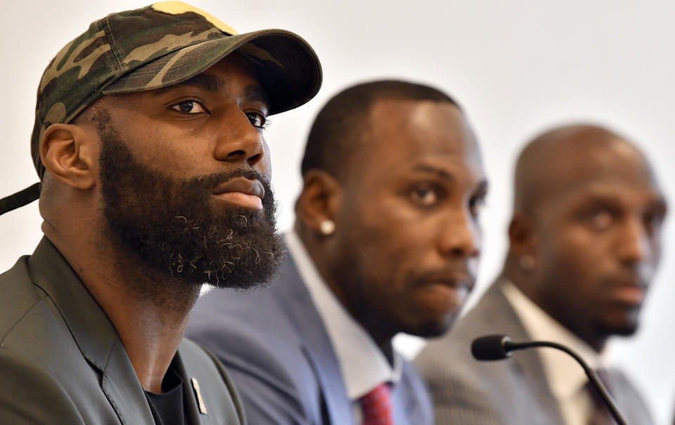 From left, the Eagles' Malcolm Jenkins, former NFL player Anquan Boldin, and the New England Patriots' Devin McCourty discuss criminal justice issues with other current and former NFL players at Harvard Law School in March. (AP)