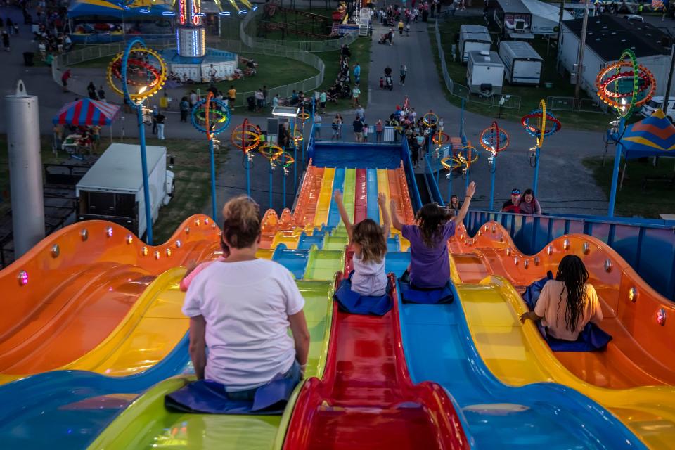 Attendees fly down a slide at the 2022 Wilson County Fair — Tennessee State Fair Thursday in Lebanon.