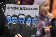 A woman holds a banner that reads: "Freedom for all political prisoners" during a rally in support of Russia's political prisoners in Belgrade, Serbia, Saturday, Jan. 21, 2023. A friendly, fellow-Slavic nation, Serbia has welcomed the fleeing Russians who need visas to travel to much richer Western European states. But in Serbia, they have not escaped the long reach of Putin's hardline regime influence.(AP Photo/Darko Vojinovic)