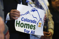 Colorado state Sen. Tony Exum Jr. holds a placard during a rally to unveil an eviction protections bill being advanced by Democratic lawmakers Wednesday, Jan. 24, 2024, in Denver. Monthly rent has outpaced income across the U.S., and forced many to make tough decisions between everyday necessities and a home. In turn, a record number of people are becoming homeless and evictions filings have ratcheted up as pandemic-era eviction moratoriums and federal assistance ends. (AP Photo/David Zalubowski)