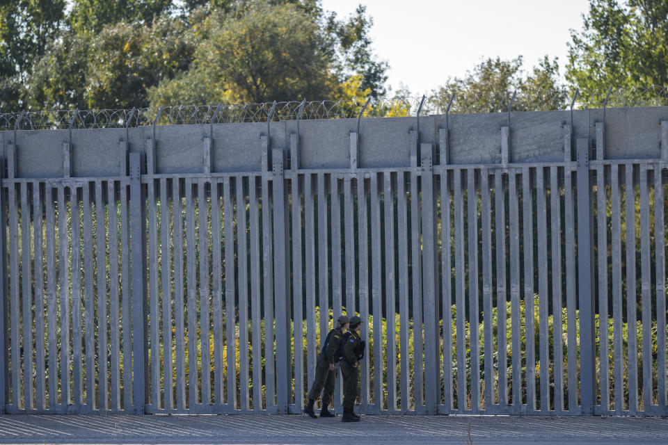 Police border guards patrol along a border wall near the town of Feres, along the Evros River which forms the the frontier between Greece and Turkey on Sunday, Oct. 30, 2022. Greece is planning a major extension of a steel wall along its border with Turkey in 2023, a move that is being applauded by residents in the border area as well as voters more broadly. (AP Photo/Petros Giannakouris)