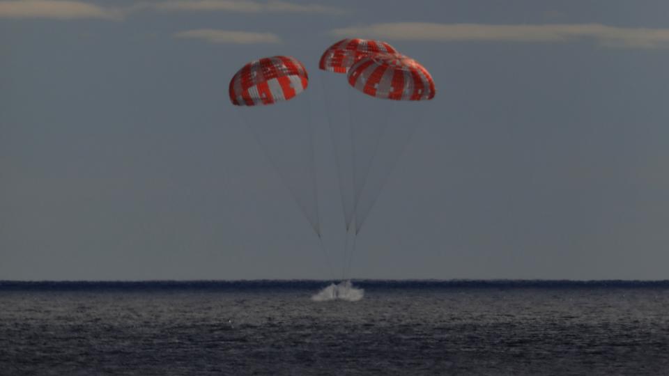 In this photo provided by NASA the Orion spacecraft for the Artemis I mission splashes down in the Pacific Ocean after a 25.5 day mission to the Moon, Sunday, Dec. 11, 2022. (NASA via AP)