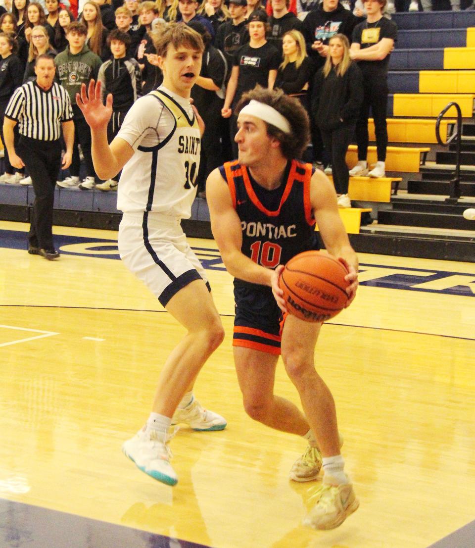 Michael Kuska of Pontiac looks for some help as Central Catholic's Trey Eller defends Friday. Kuska had 11 points in the PTHS win.