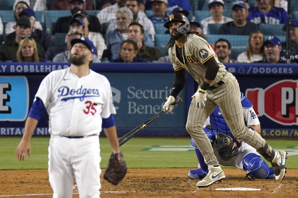 San Diego Padres' Fernando Tatis Jr., right, heads to first for a solo home run as Los Angeles Dodgers starting pitcher Lance Lynn watches during the fifth inning of a baseball game Tuesday, Sept. 12, 2023, in Los Angeles. (AP Photo/Mark J. Terrill)