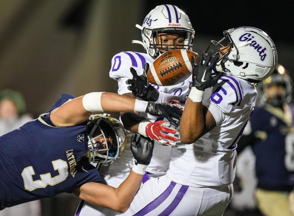 Ben Davis Giants Alvin Contreras (6) catches the ball for an interception against Cathedral Fighting Irish Zach Meeks (3) on Friday, Nov. 10, 2023, during the IHSAA Class 6A regional championship game at Key Stadium at University of Indianapolis. The Ben Davis Giants defeated the Cathedral Fighting Irish, 27-24.