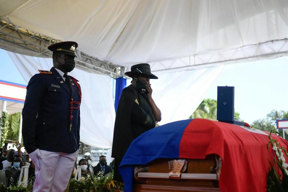 Former first lady of Haiti, Martine Moïse, stands by the casket of her slain husband, former President Jovenel Moïse, during his funeral at his family home in Cap-Haitien, Haiti, Friday, July 23, 2021. Martine Moïse was injured in the July 7 attack at their private home, and returned to Haiti following her release from a Miami hospital.