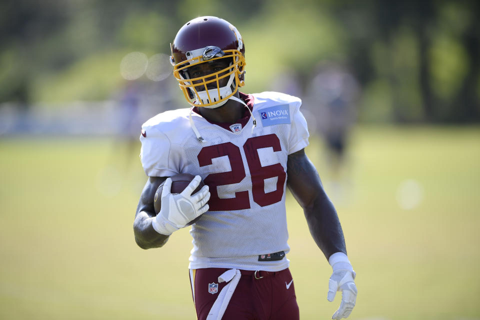 Washington running back Adrian Peterson (26) holds the ball during practice at the team's NFL football training facility, Monday, Aug. 24, 2020, in Ashburn, Va. (AP Photo/Nick Wass)