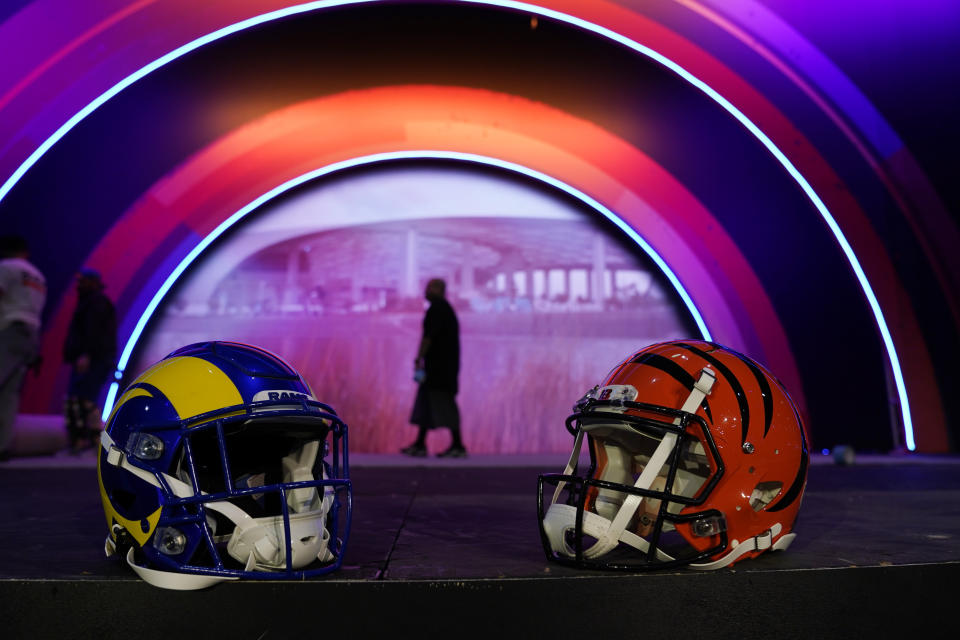 Los Angeles Rams and Cincinnati Bengals helmets rest on a stage inside the NFL Experience, an interactive fan show, Friday, Feb. 4, 2022, at the Los Angeles Convention Center in Los Angeles. The Los Angeles Rams are scheduled to play the Cincinnati Bengals in the Super Bowl NFL football game Feb. 13 in Inglewood, Calif. (AP Photo/Marcio Jose Sanchez)