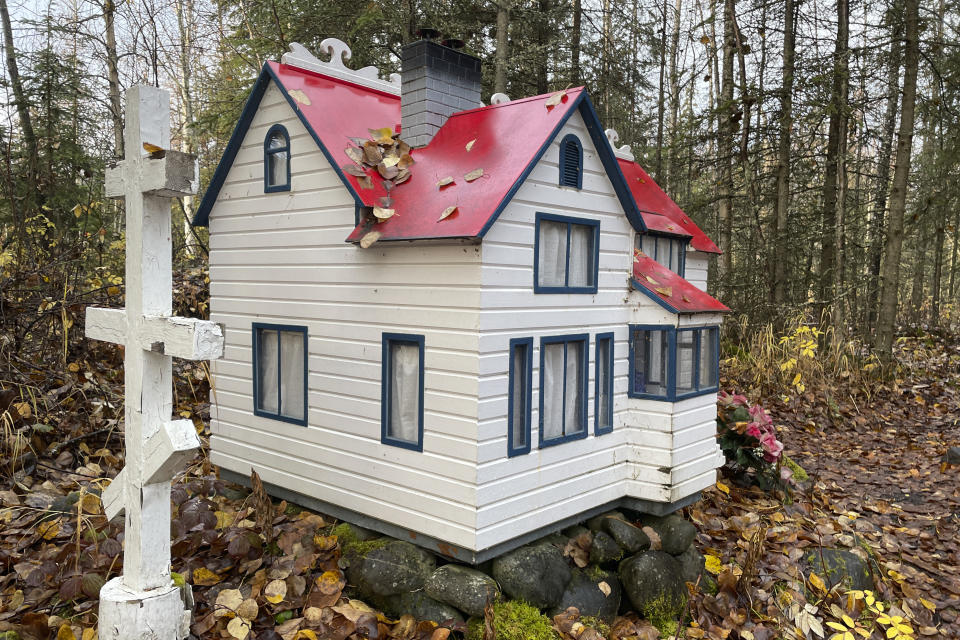 The cemetery at St. Nicholas Church is shown in Eklutna, Alaska, which features a mixture of Russian Orthodox conventions like crosses featuring three cross beams and the Dena'ina Athabascan tradition of erecting spirit homes above the graves, on Oct. 13, 2023. A restoration effort has begun on the old St. Nicholas Church, which is the oldest standing building in the Municipality of Anchorage. (AP Photo/Mark Thiessen)