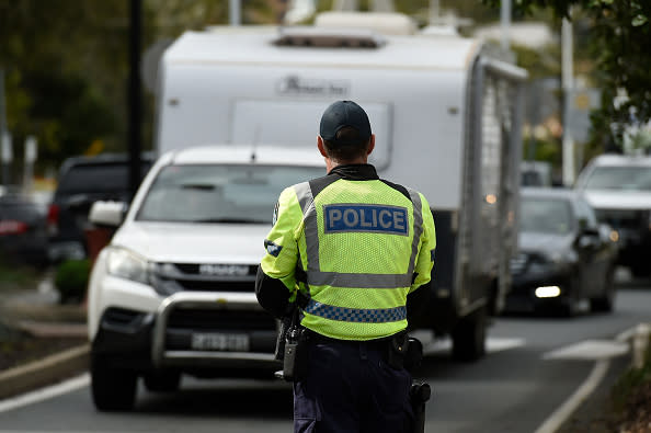 Police are seen at the Griffith Street checkpoint at Coolangatta, Australia. 