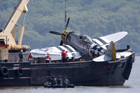 <p>Officials remove a plane from the Hudson River a day after it crashed, Saturday, May 28, 2016, in North Bergen, N.J. The World War II vintage P-47 Thunderbolt aircraft crashed into the river Friday, May 27, 2016, killing its pilot. (AP Photo/Julio Cortez) </p>